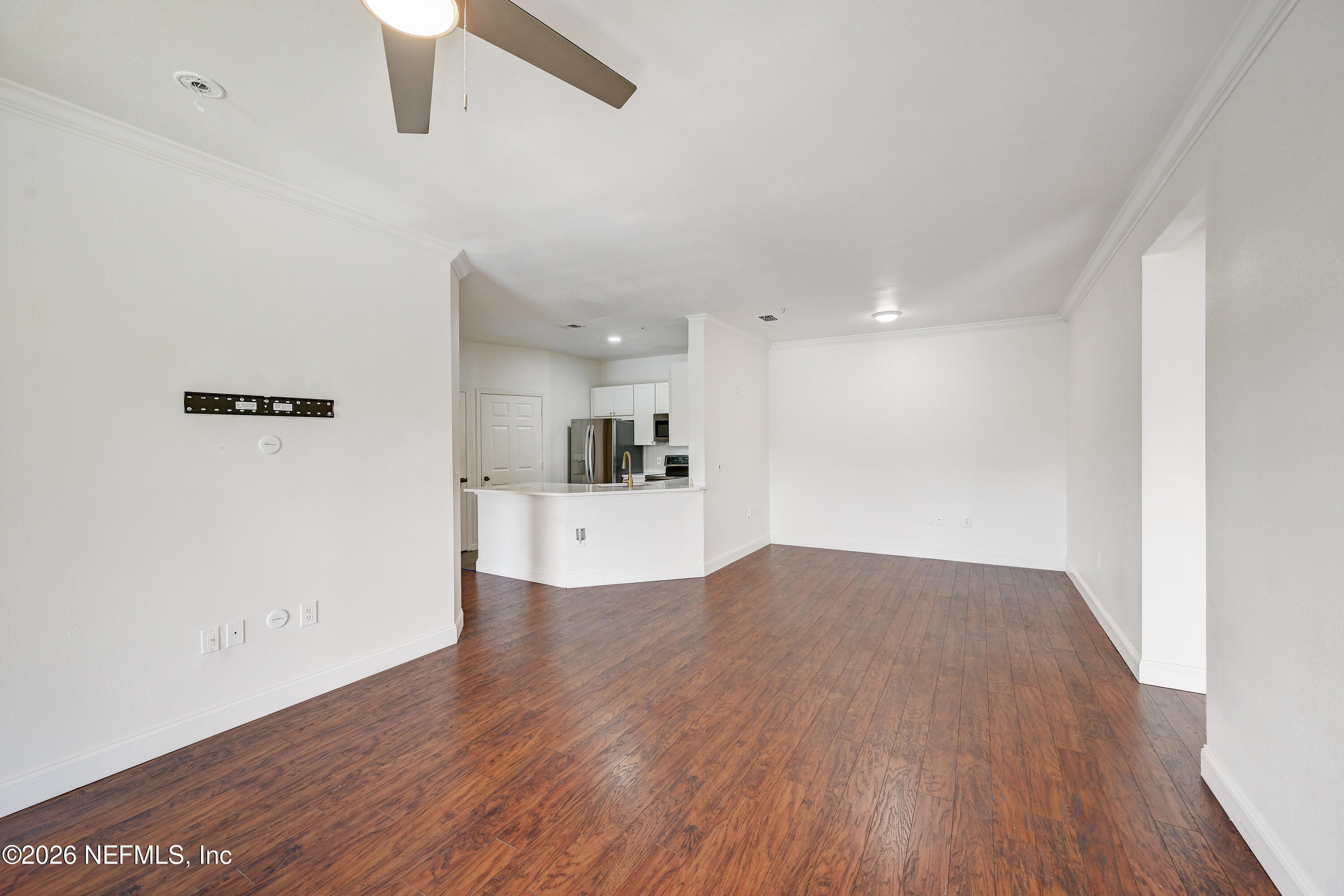 10961 Burnt Mill Road, Unit 824 Jacksonville, FL 32256 - Photo 8 of 35 a view of kitchen and empty room with wooden floor