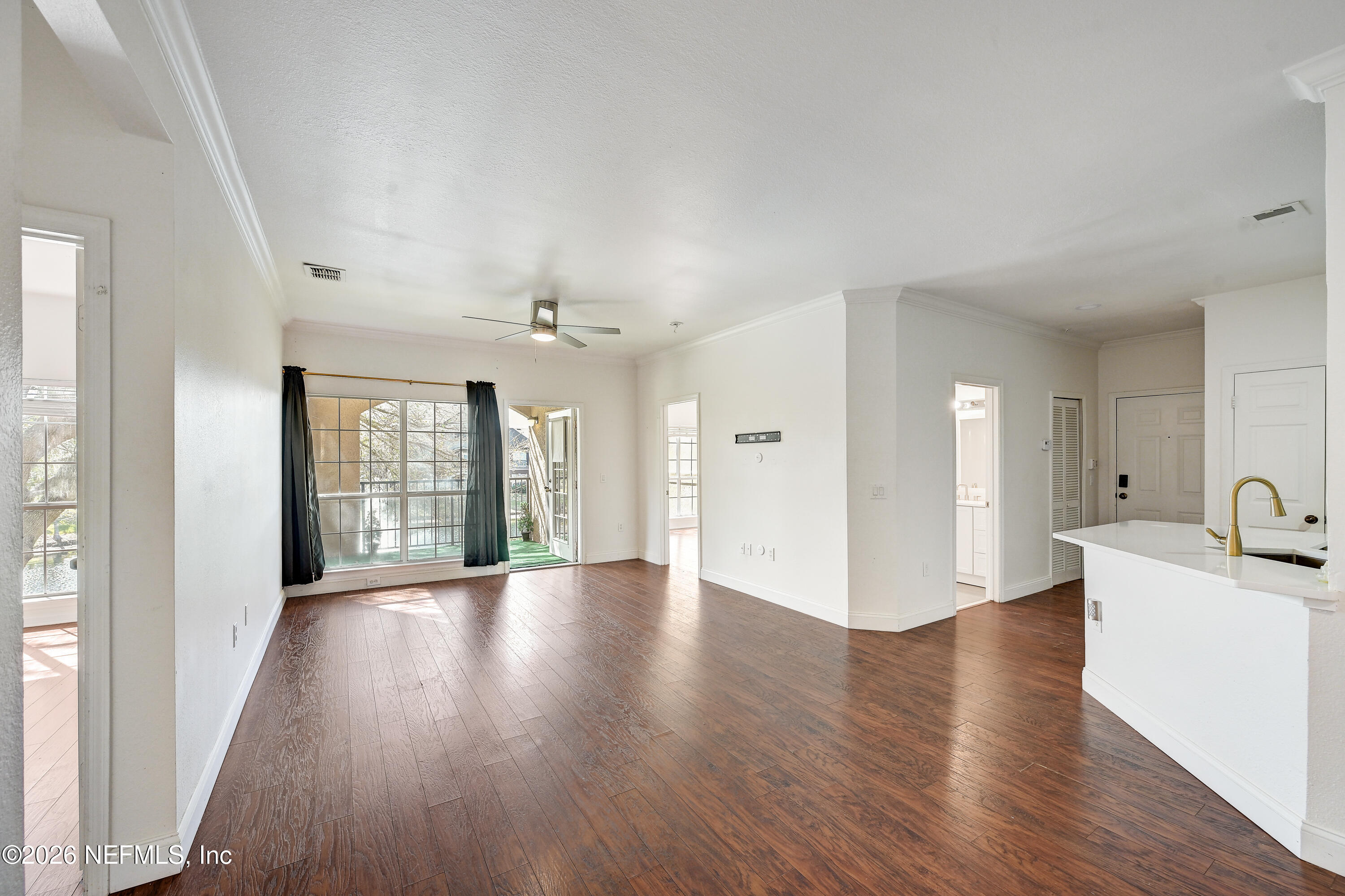 10961 Burnt Mill Road, Unit 824 Jacksonville, FL 32256 - Photo 9 of 35 wooden floor in an empty room with a window