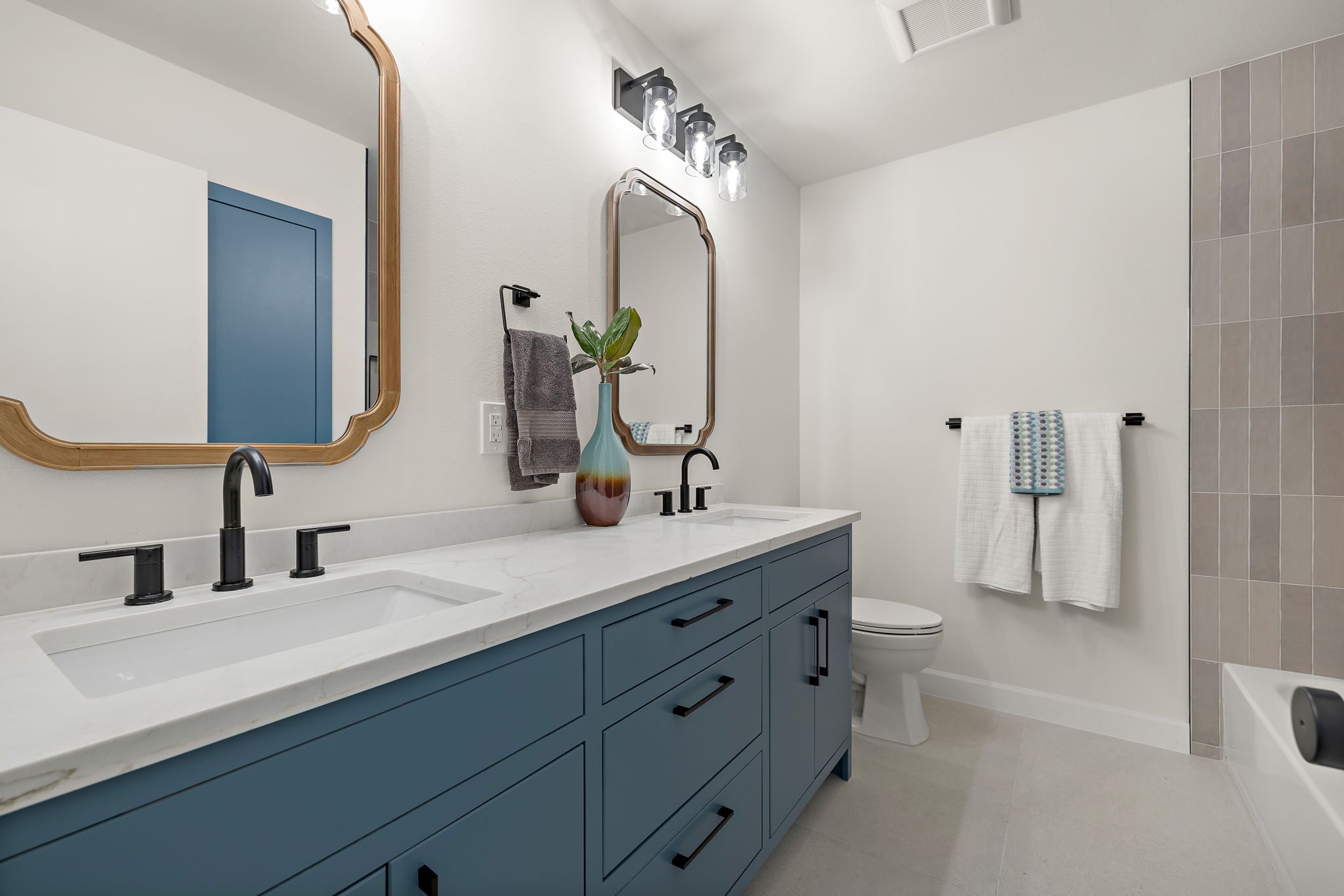 8102 Burrell Drive Austin, TX 78757 - Photo 27 of 35 a bathroom with a double vanity sink mirror and shower