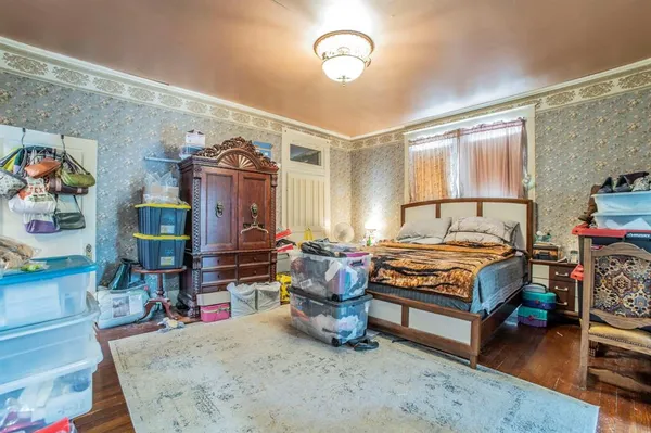 a bedroom with furniture and a flat screen tv