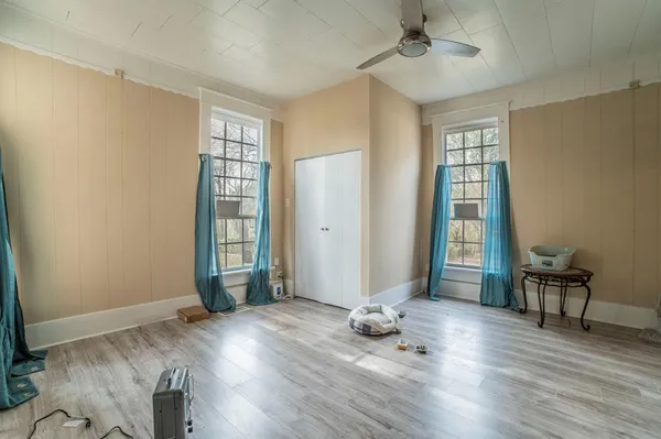 wooden floor in an empty room with a window