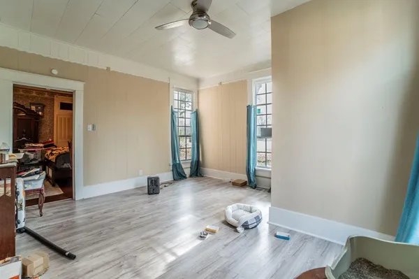 a view of empty room with wooden floor