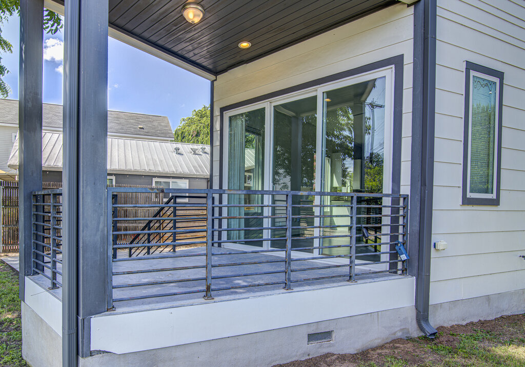 2406 East 16th Street Austin, TX 78702 - Photo 5 of 39 a view of house with a large window and wooden floor