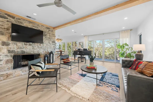 a living room with furniture a flat screen tv and a fireplace
