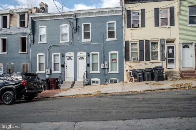 a view of a street that has couple of cars parked on the road