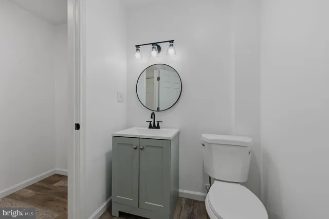 a bathroom with a toilet a sink and mirror