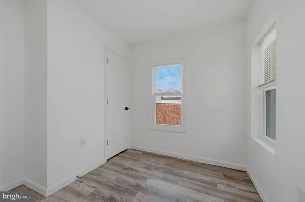 a view of an empty room and wooden floor