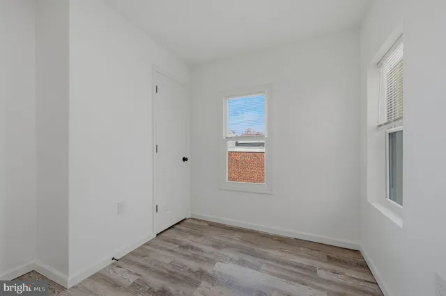 a view of an empty room and wooden floor