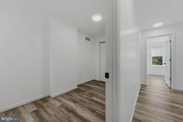 a view of a hallway with wooden floor