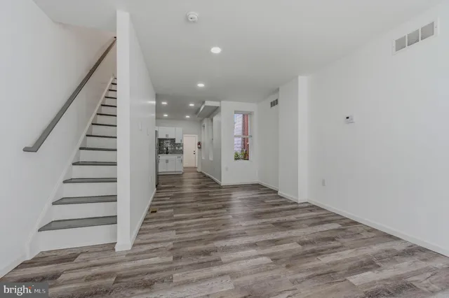 a view of entryway and hall with wooden floor