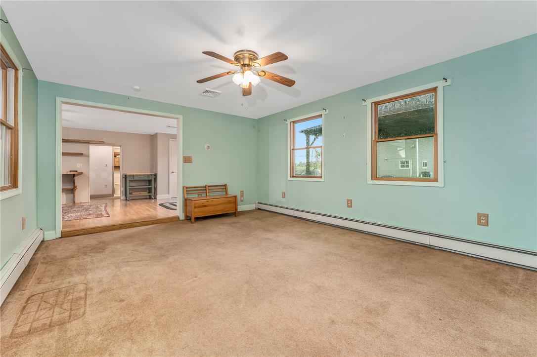 4831 Steuben Road Nazareth, PA 18064 - Photo 10 of 34 A comfortable living space boasts a ceiling fan, carpet flooring, and abundant natural light.