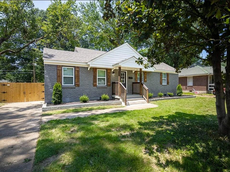 a front view of a house with yard patio and green space