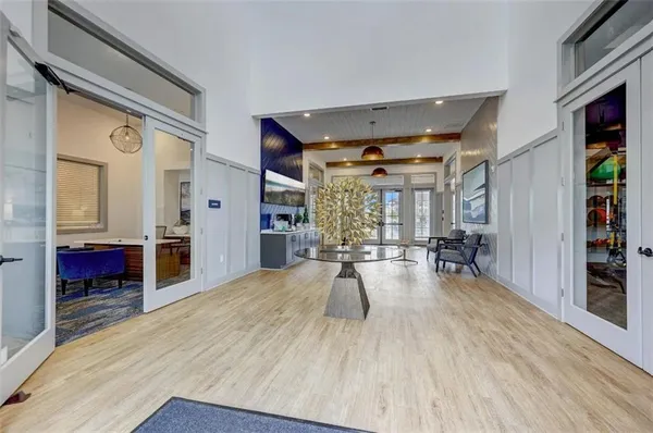 a kitchen with stainless steel appliances a dining table chairs refrigerator and sink