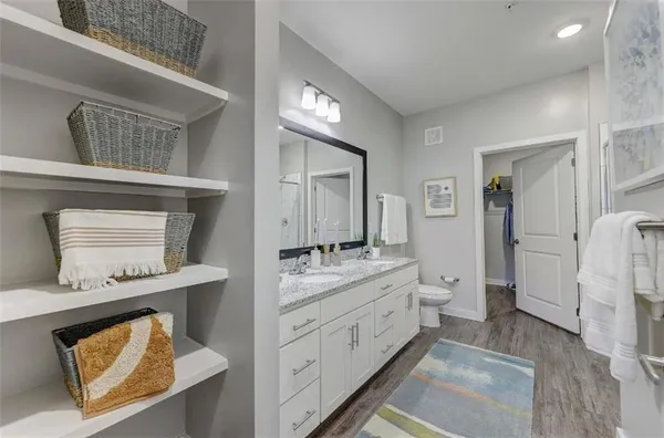 a bathroom with a refrigerator and a double vanity