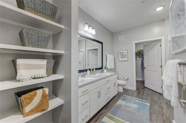 a bathroom with a refrigerator and a double vanity