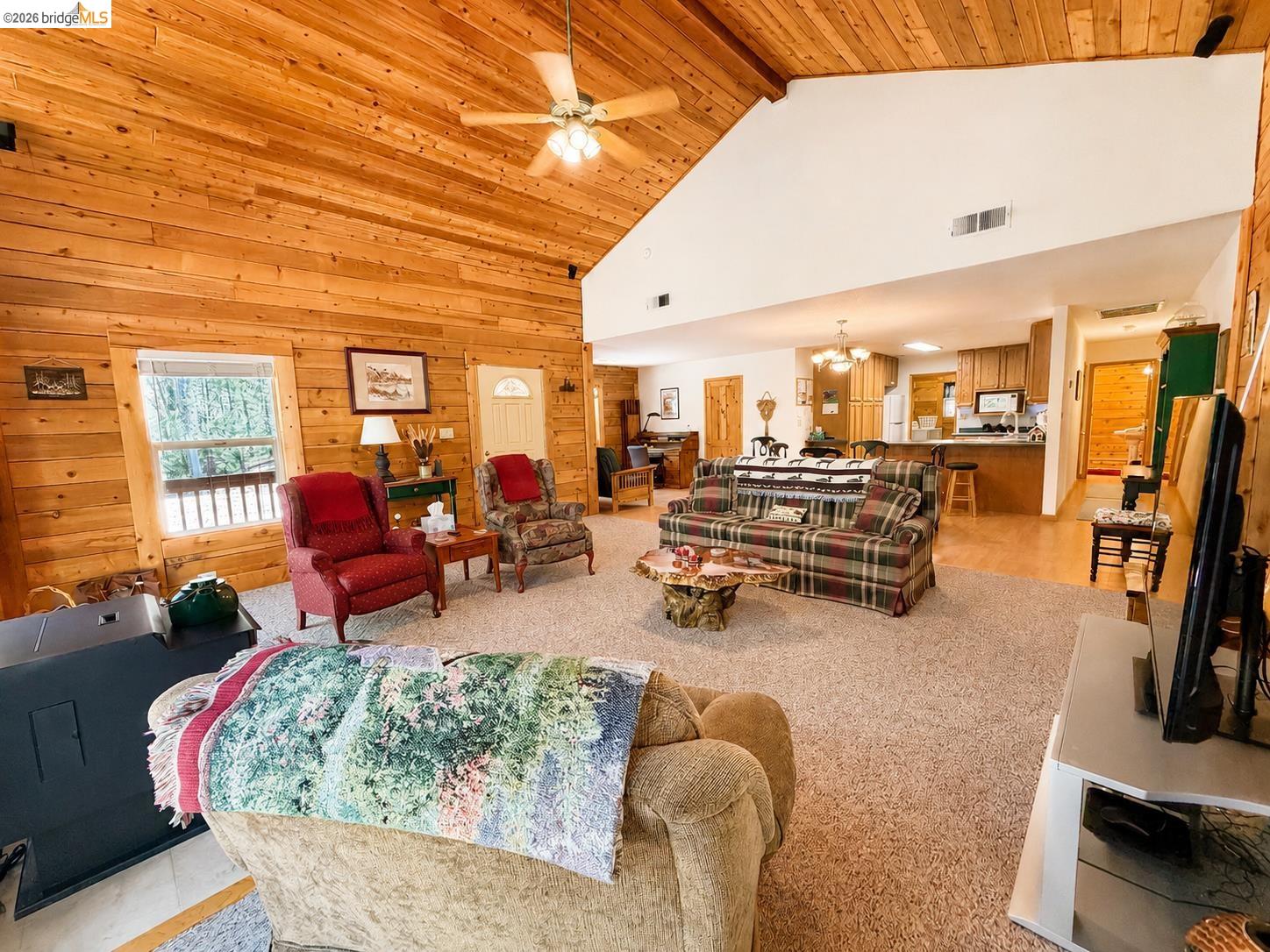 21181 Phoenix Lake Road Sonora, CA 95370 - Photo 8 of 34 Expansive open-concept living space featuring wood-paneled walls and a vaulted wood-finish ceiling