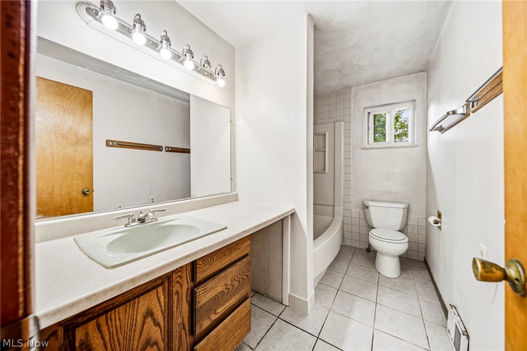 1694 Ridgewick Drive Wickliffe, OH 44092 - Photo 22 of 30 Bathroom featuring a single vanity with wood-finish cabinetry, a white countertop, and an integrated sink