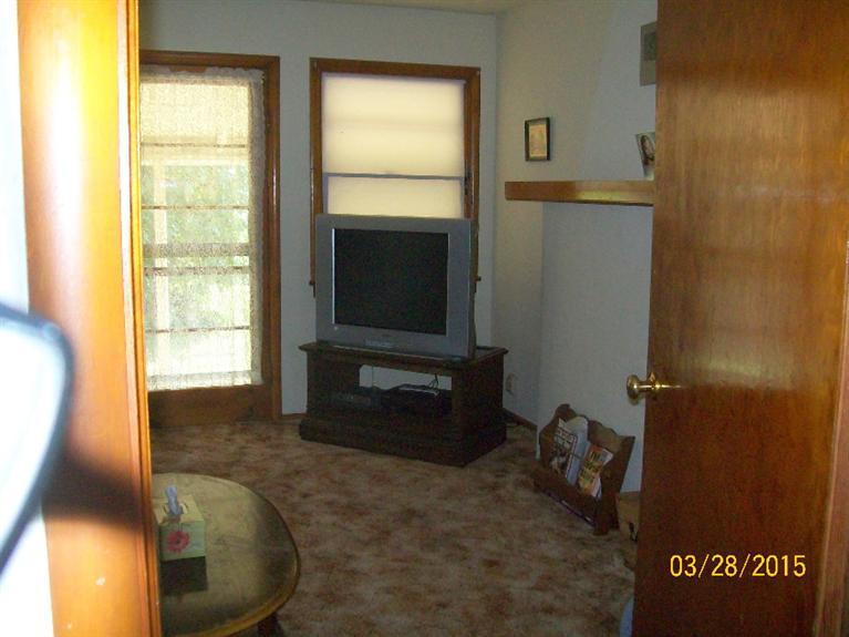 5015 Waldo Road Cave Junction, OR 97523 - Photo 13 of 35 a living room with a bed furniture and a flat screen tv