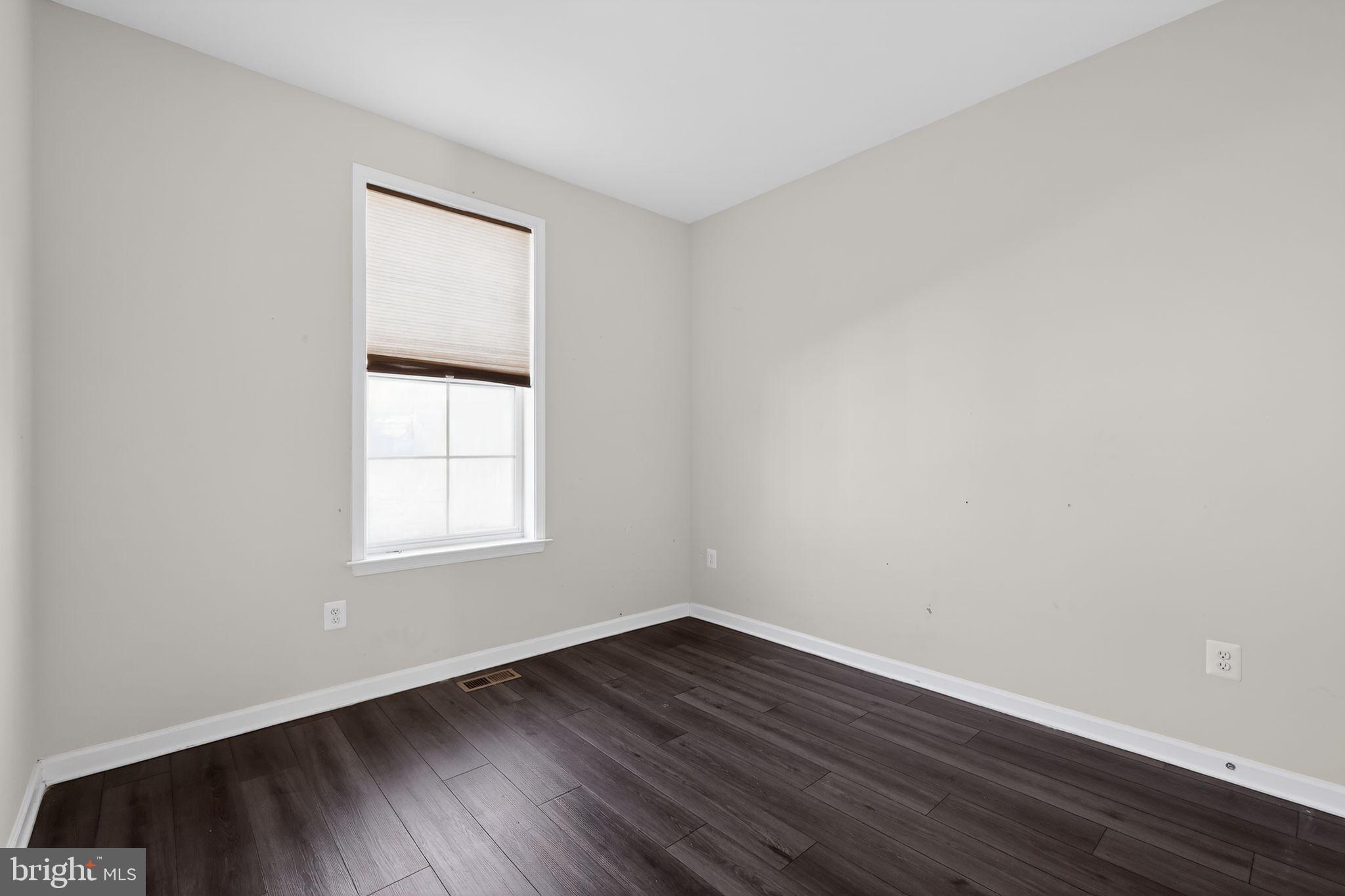 1027 Overlook Way Laurel, MD 20707 - Photo 11 of 30 an empty room with wooden floor and windows