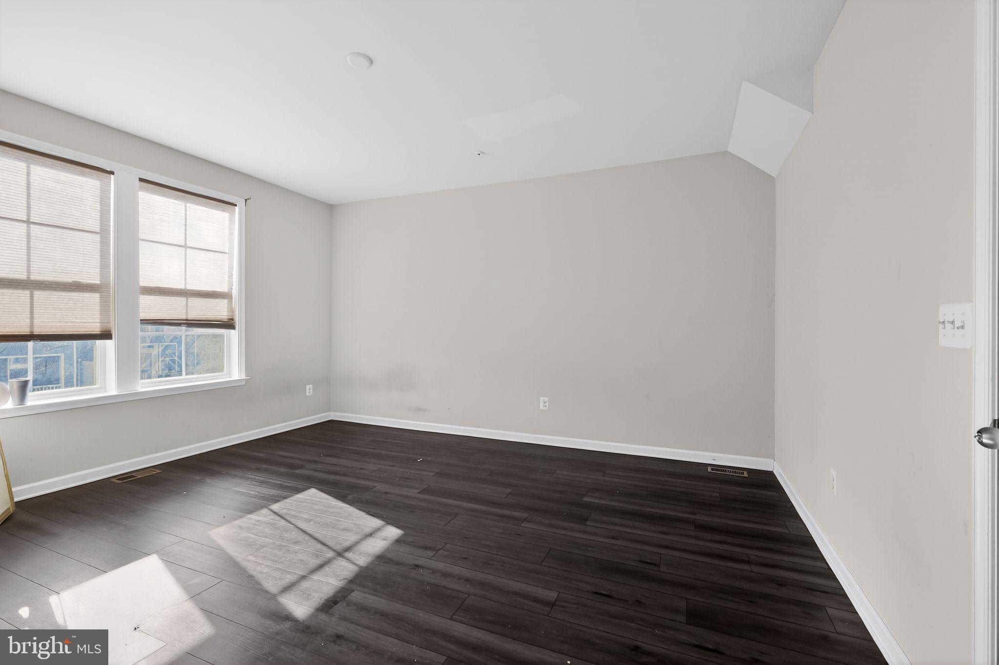 1027 Overlook Way Laurel, MD 20707 - Photo 13 of 30 an empty room with wooden floor and windows