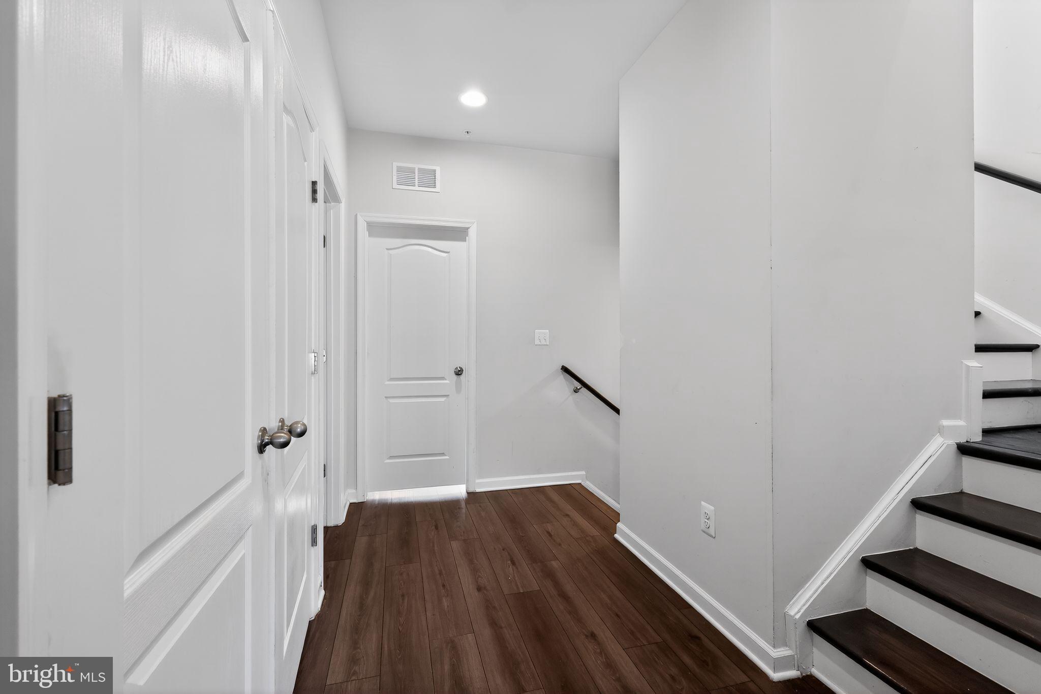 1027 Overlook Way Laurel, MD 20707 - Photo 17 of 30 a view of a hallway with wooden floor and staircase