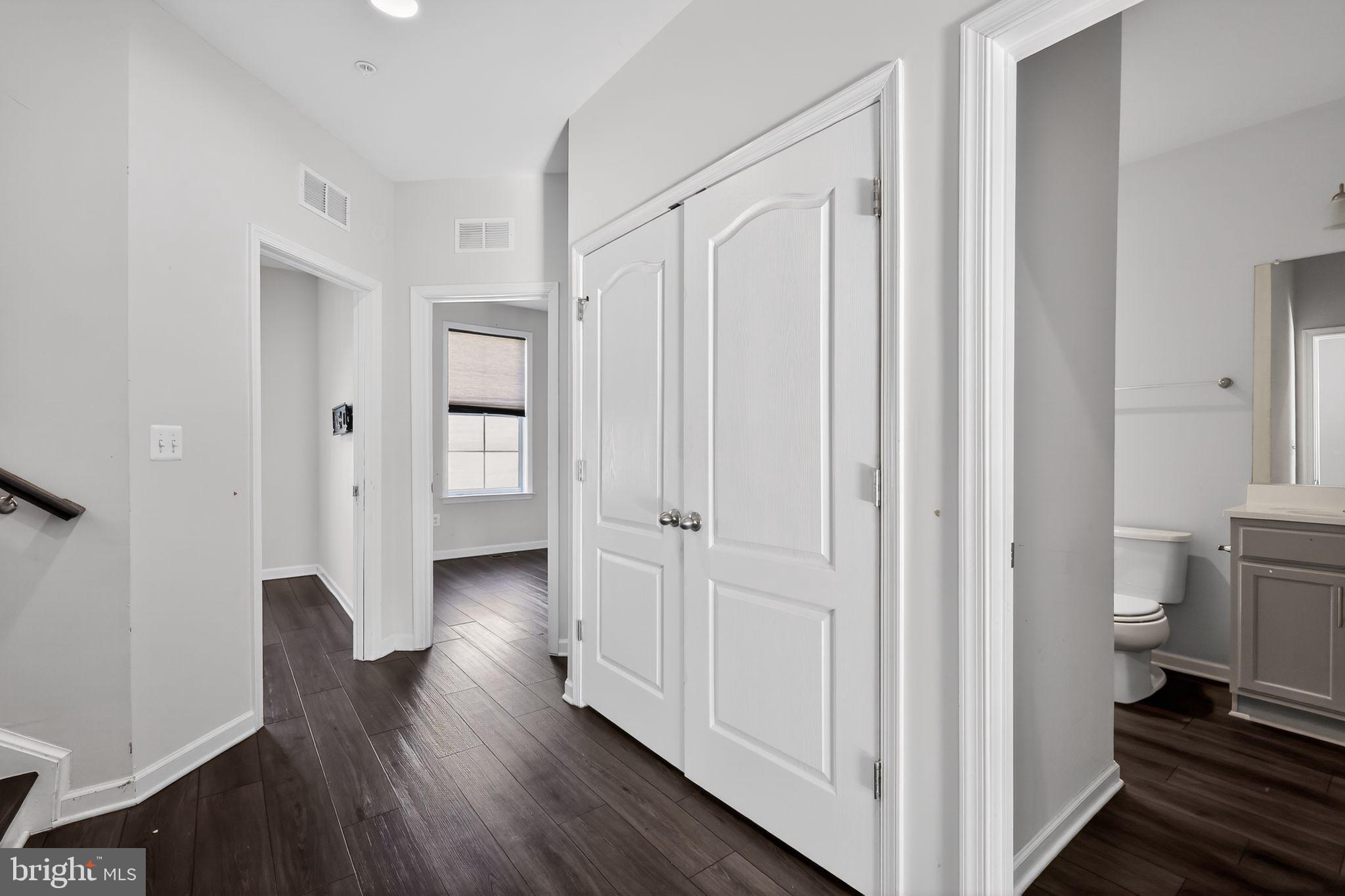 1027 Overlook Way Laurel, MD 20707 - Photo 18 of 30 a view of a hallway with wooden floor and closet area