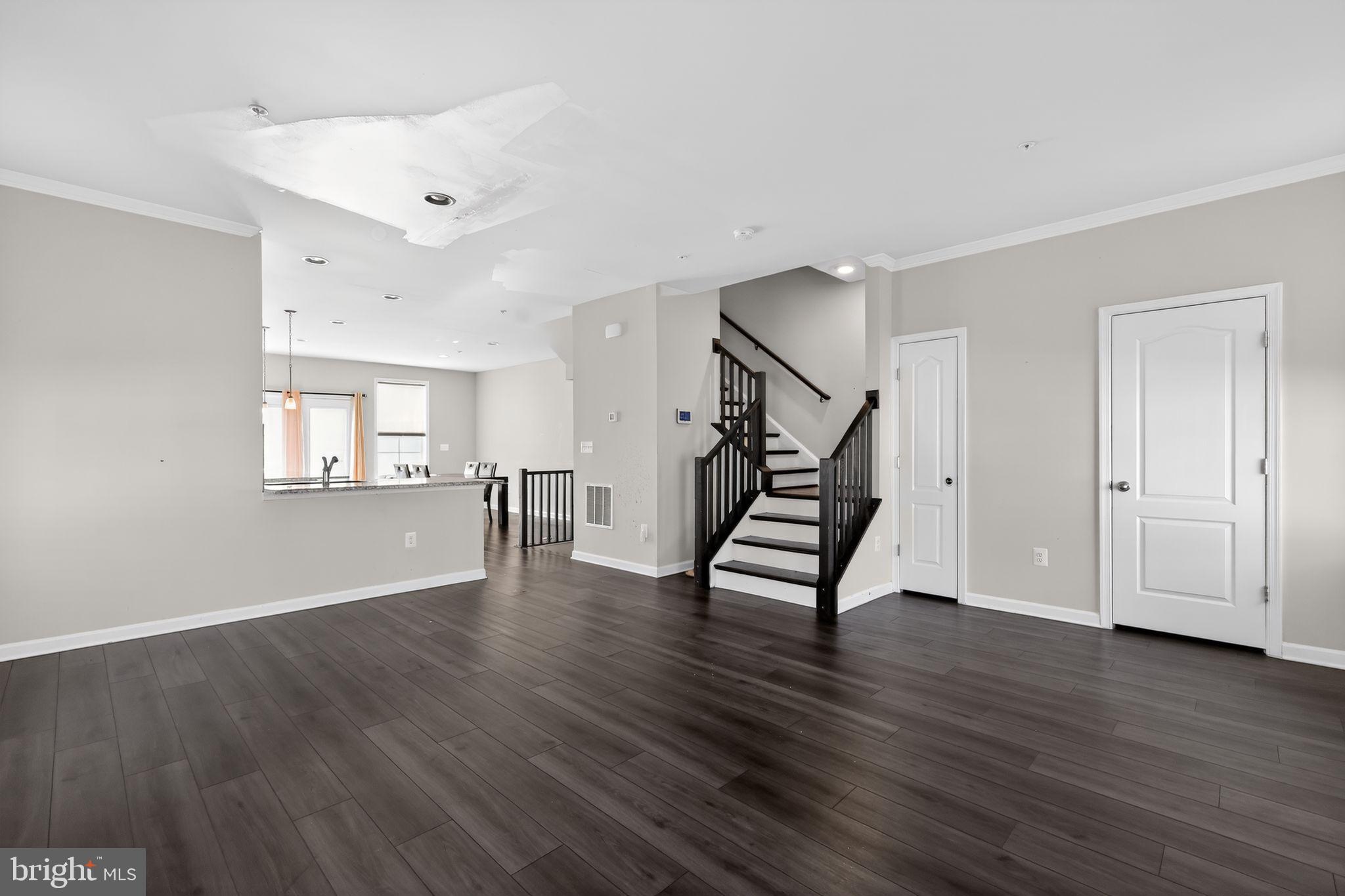 1027 Overlook Way Laurel, MD 20707 - Photo 3 of 30 a view of an empty room with wooden floor and a window