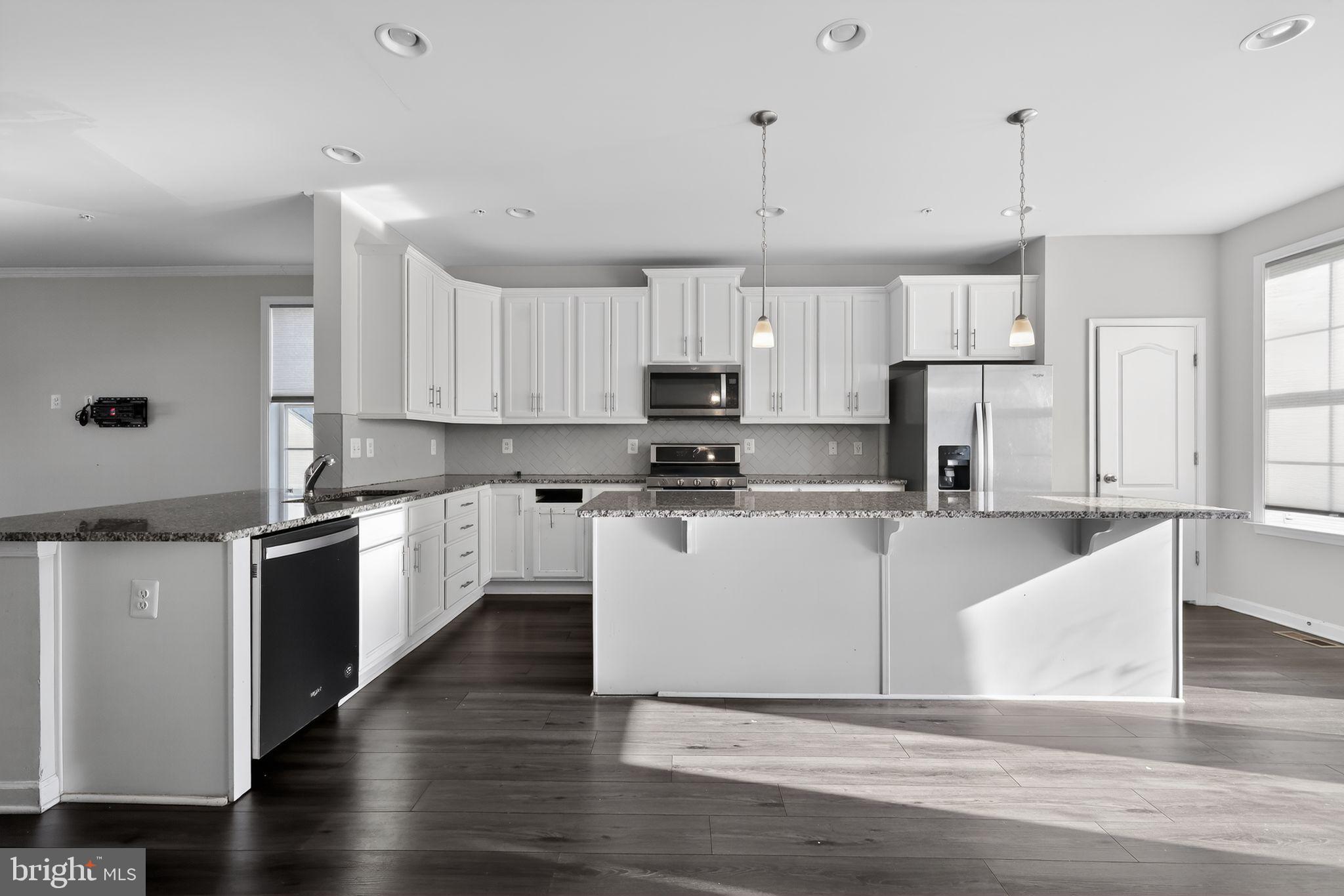 1027 Overlook Way Laurel, MD 20707 - Photo 6 of 30 a large kitchen with cabinets and wooden floor