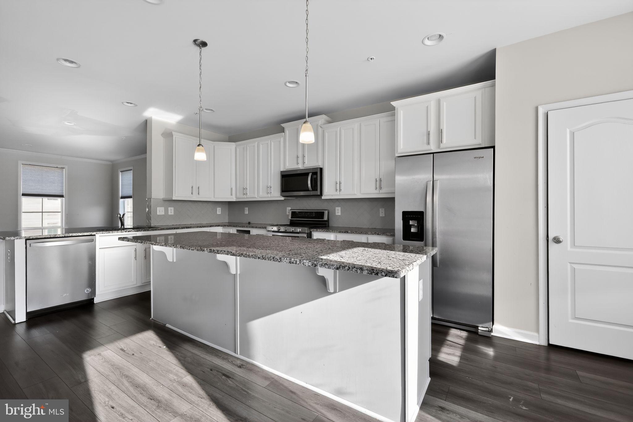 1027 Overlook Way Laurel, MD 20707 - Photo 7 of 30 a kitchen with kitchen island a counter space a sink appliances and cabinets