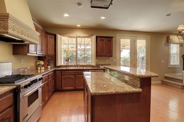 8916 Visage Circle Fair Oaks, CA 95628 - Photo 2 of 15 a kitchen with granite countertop sink stove and cabinets