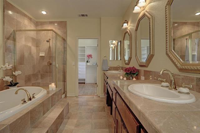 8916 Visage Circle Fair Oaks, CA 95628 - Photo 4 of 15 a bathroom with a granite countertop sink a mirror a bathtub and shower