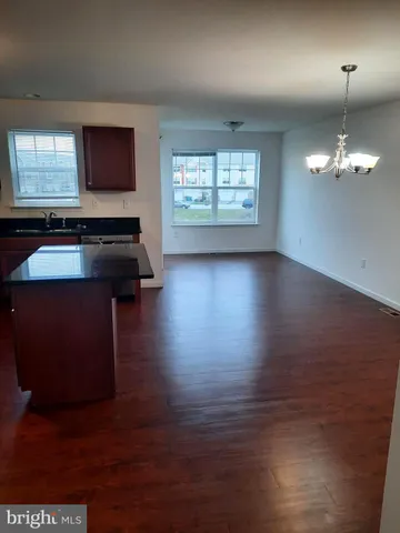 a living room with hard wood floors and a window