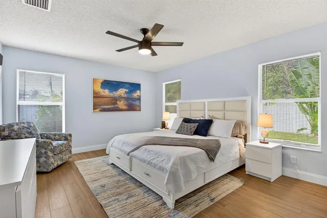 a bedroom with a large bed and a window