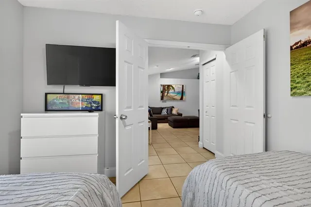 a bedroom with a bed and flat screen tv