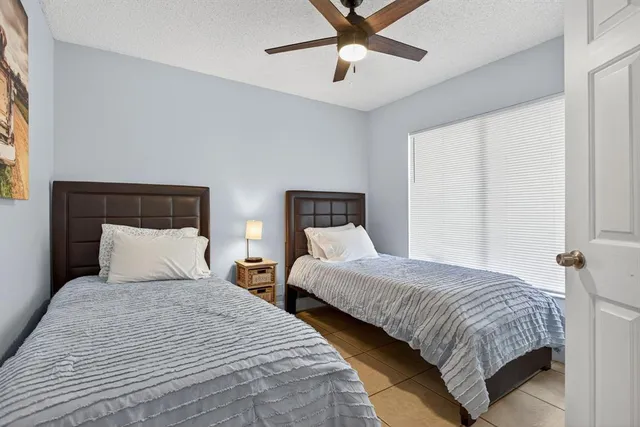 a bedroom with two beds and painting on the wall