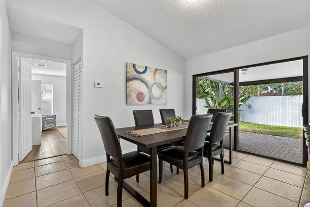 a view of a dining room with furniture large window and outside view