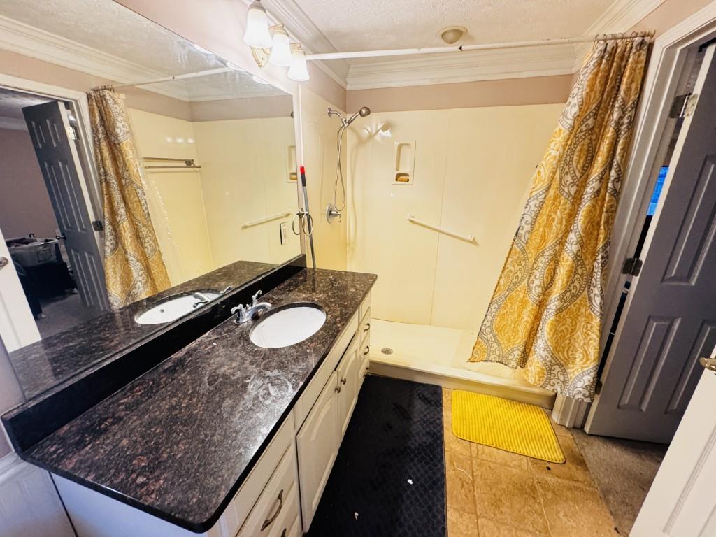 2359 Valley Way Snellville, GA 30078 - Photo 15 of 26 a bathroom with a granite countertop sink and a mirror
