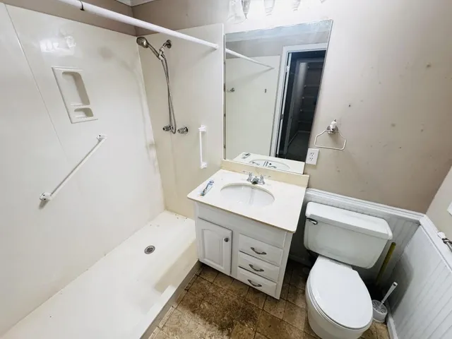 a bathroom with a sink toilet and shower