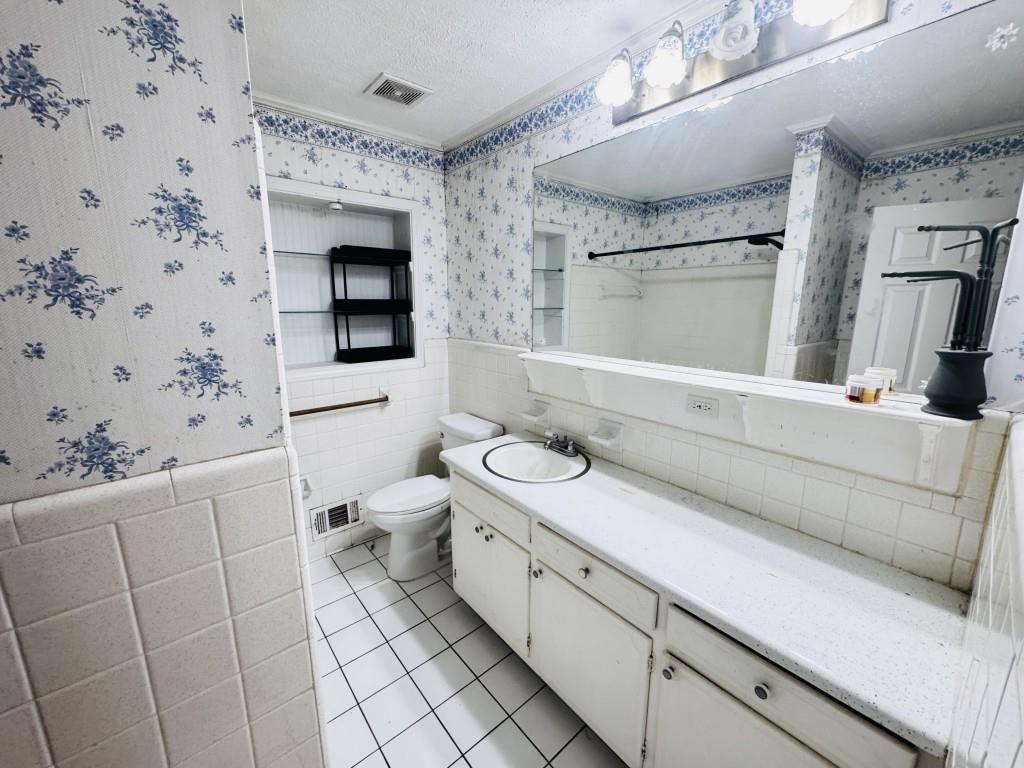 2359 Valley Way Snellville, GA 30078 - Photo 21 of 26 a bathroom with a granite countertop sink mirror vanity and toilet