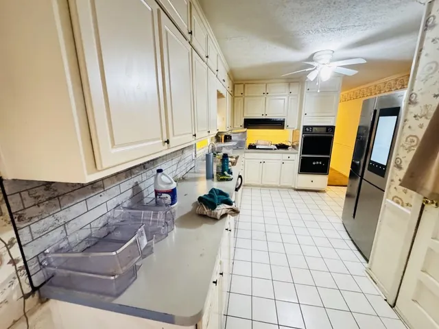 a kitchen with a sink and a refrigerator
