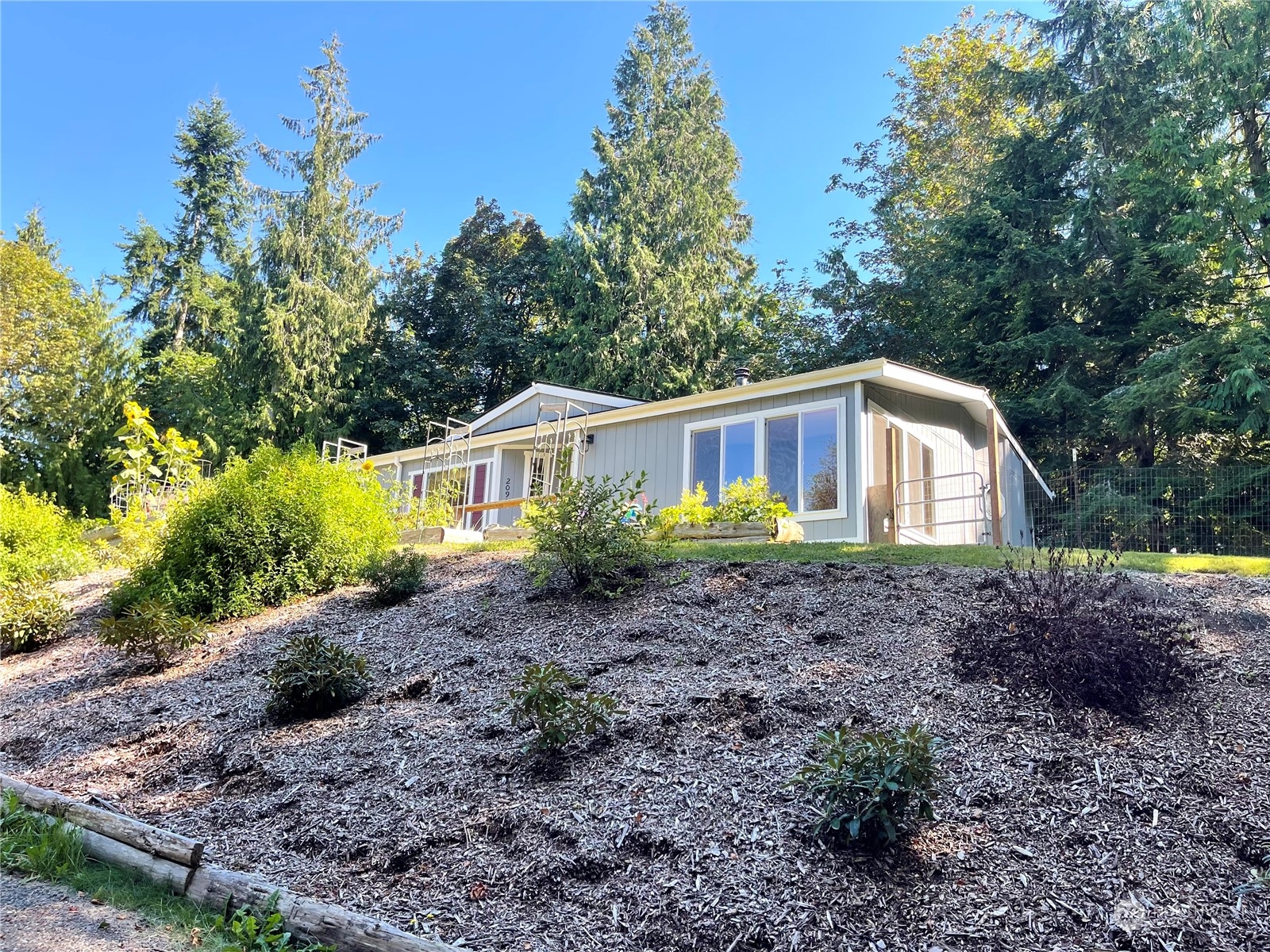 2090 Anderson Lake Road Chimacum, WA 98325 - Photo 2 of 25 a view of a house with a yard and potted plants