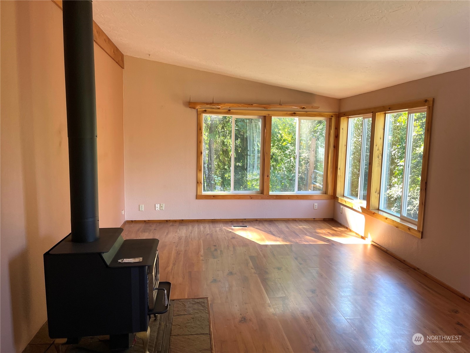 2090 Anderson Lake Road Chimacum, WA 98325 - Photo 7 of 25 a view of an empty room with wooden floor and a window
