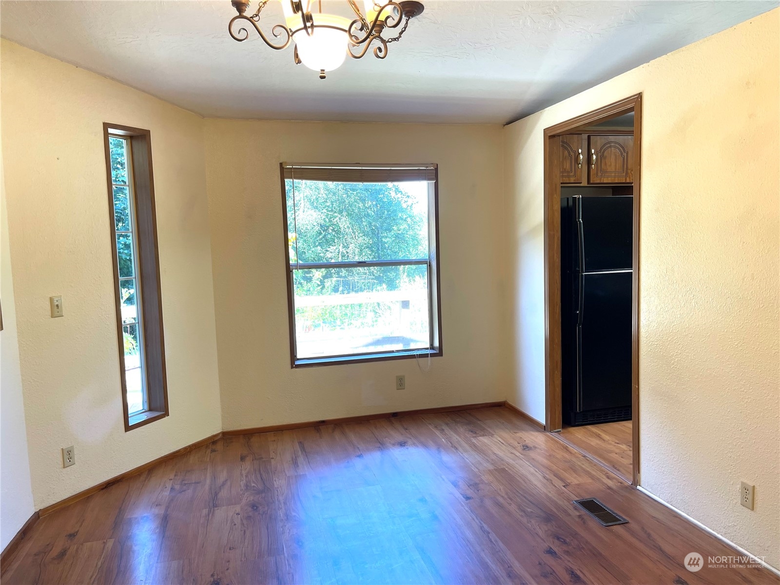 2090 Anderson Lake Road Chimacum, WA 98325 - Photo 8 of 25 a view of an empty room with wooden floor and a window