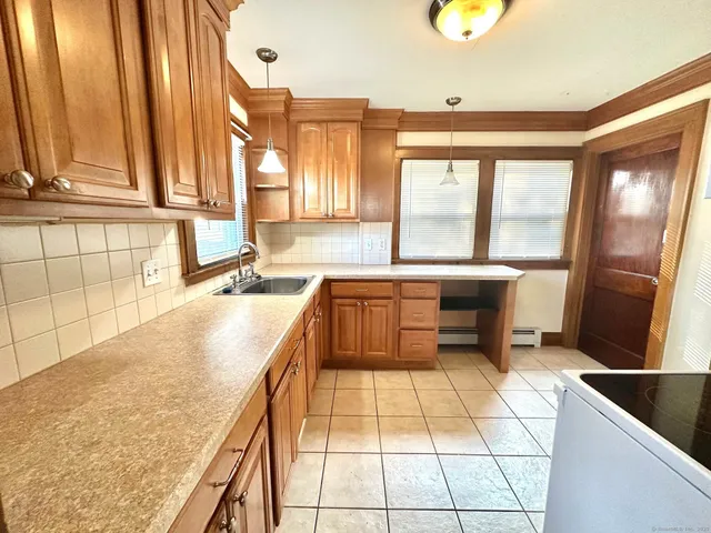 a kitchen with granite countertop a sink and a counter top space