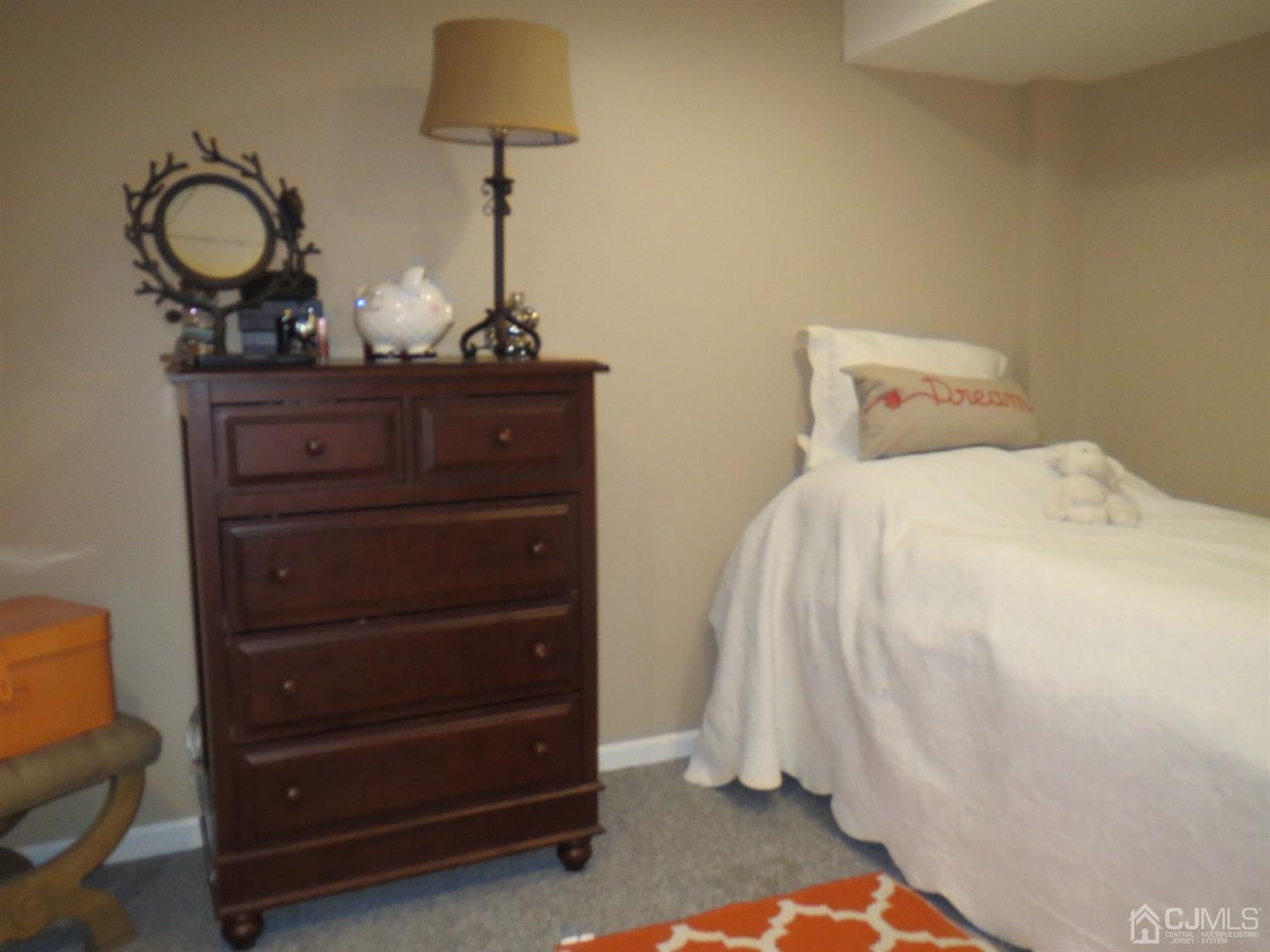 43 Princeton Road Old Bridge, NJ 08859 - Photo 18 of 26 a bedroom with a bed and a chandelier