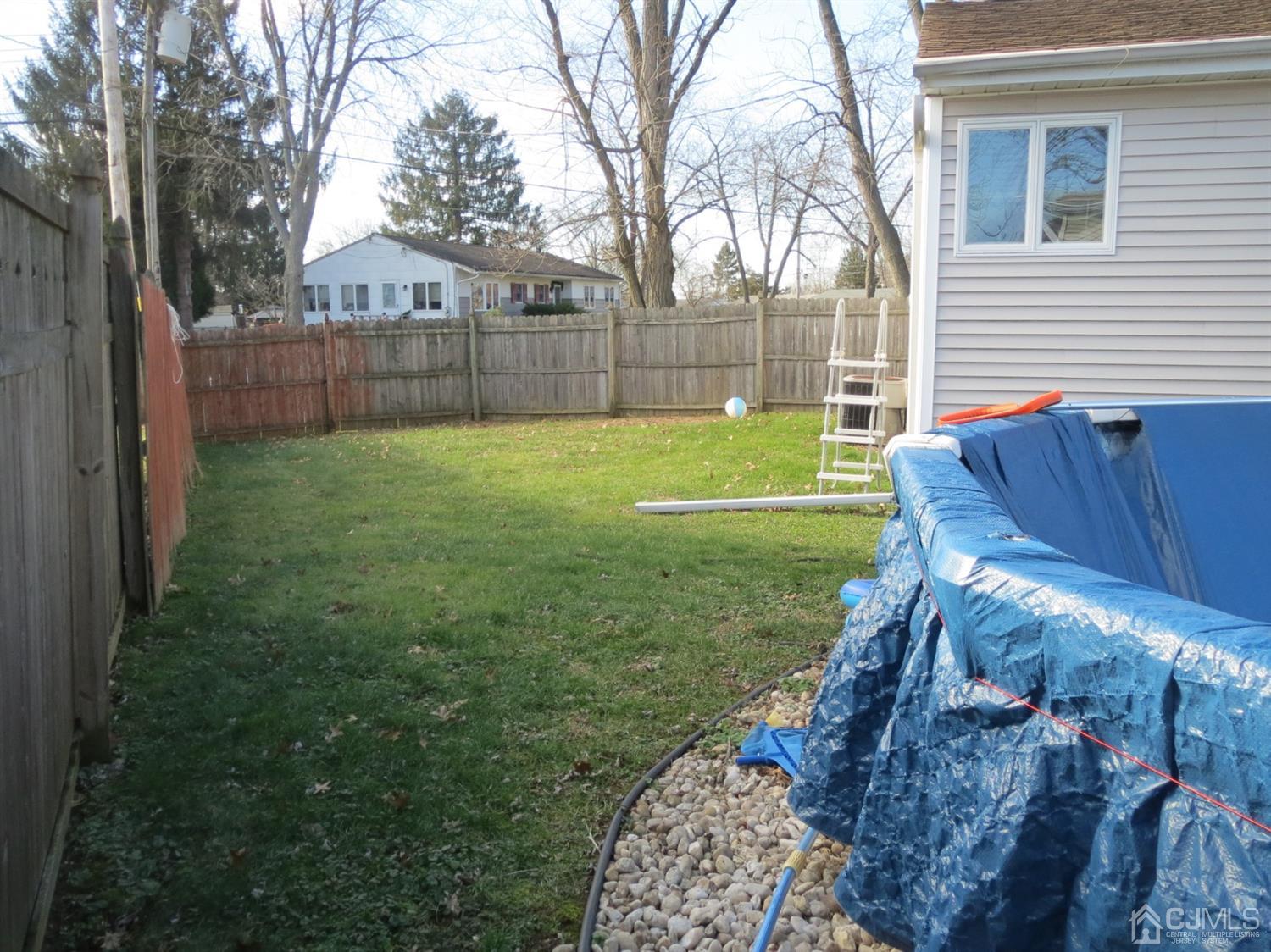 43 Princeton Road Old Bridge, NJ 08859 - Photo 24 of 26 a view of backyard with wooden fence and large trees