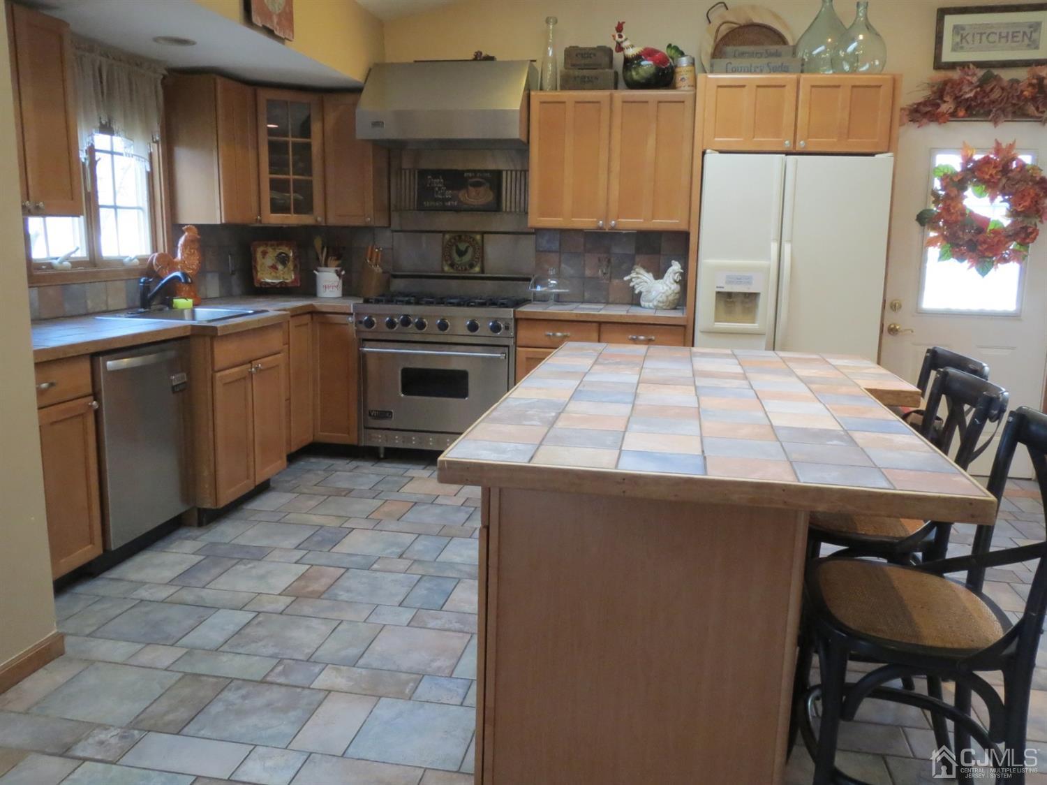 43 Princeton Road Old Bridge, NJ 08859 - Photo 5 of 26 a kitchen with a stove a sink a microwave and cabinets