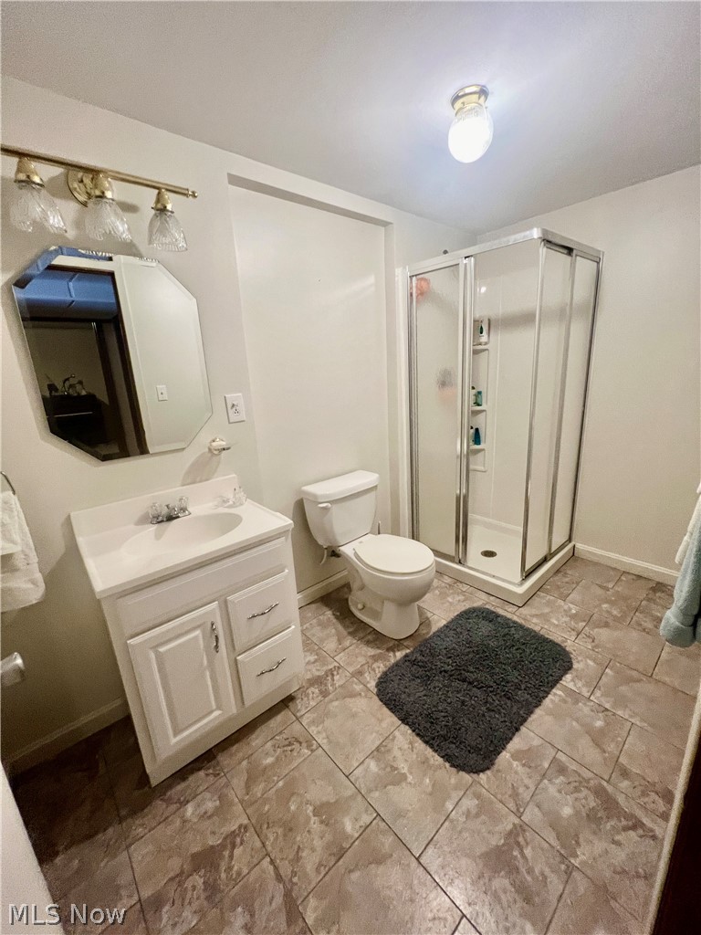 53360 High Ridge Road Bridgeport, OH 43912 - Photo 24 of 41 Bathroom with tile flooring, a shower with shower door, oversized vanity, and toilet