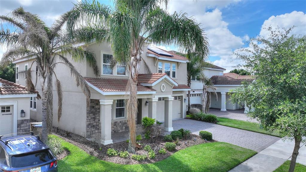 1089 Blackwolf Run Road Davenport, FL 33896 - Photo 45 of 82 a front view of a house with a garden and a tree