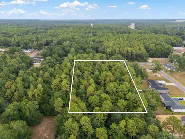 an aerial view of houses with yard and outdoor space